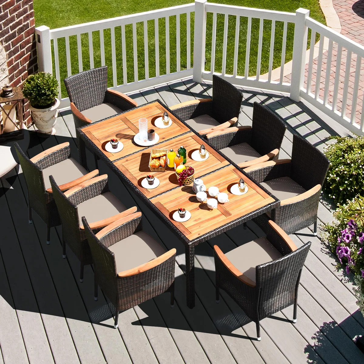 Costway 9-piece patio dining set with acacia wood table top and 8 stackable rattan chairs