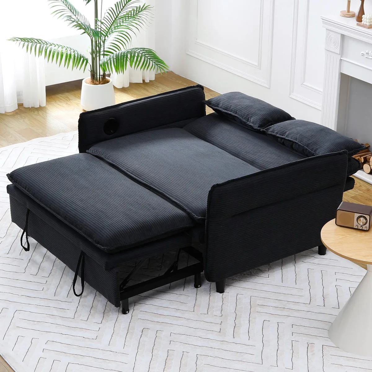 Black corduroy sofa bed with letter-striped fabric, adjustable armrests and backrest, pull-out bed mechanism
