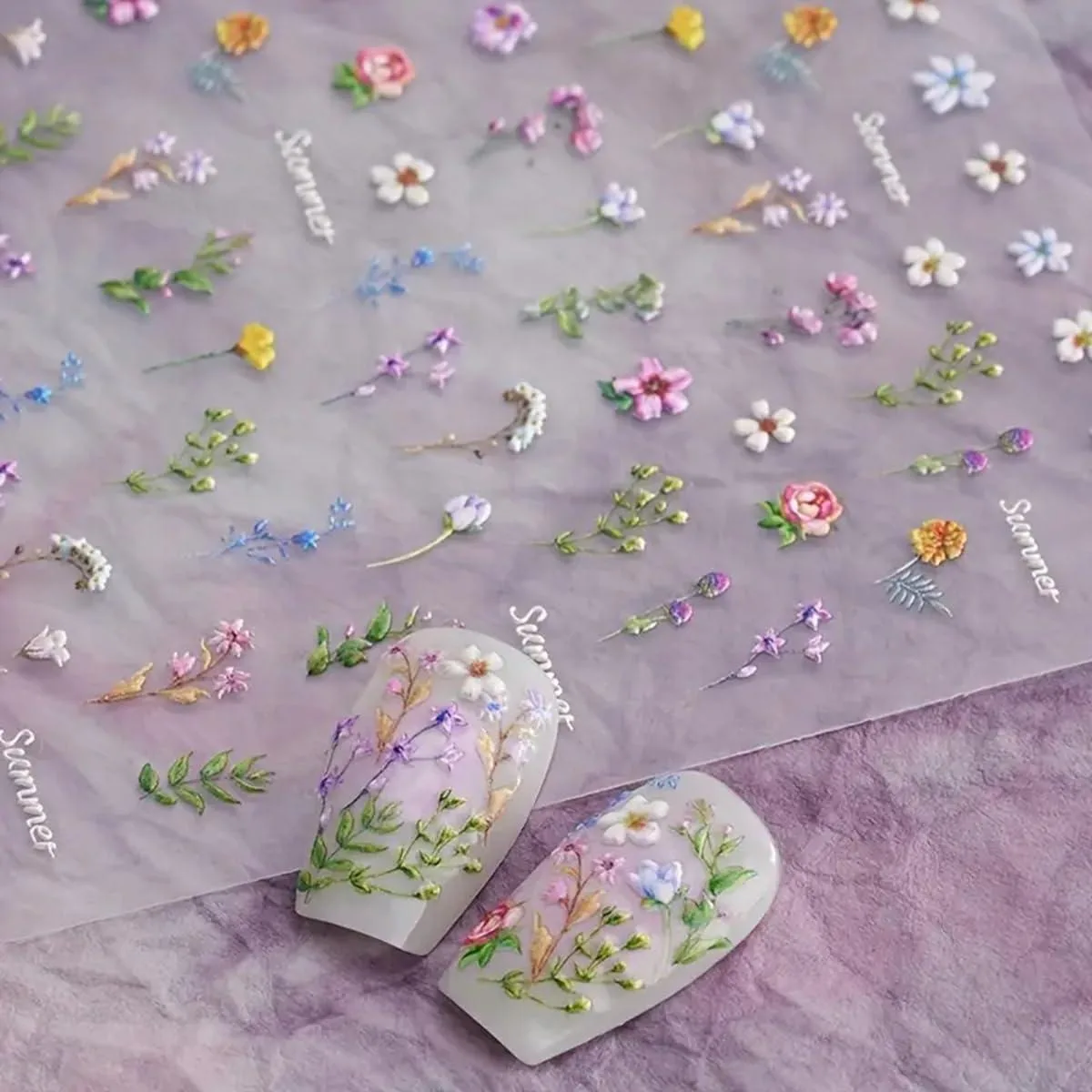 A single sheet of multi-coloured 5D embossed floral nail stickers