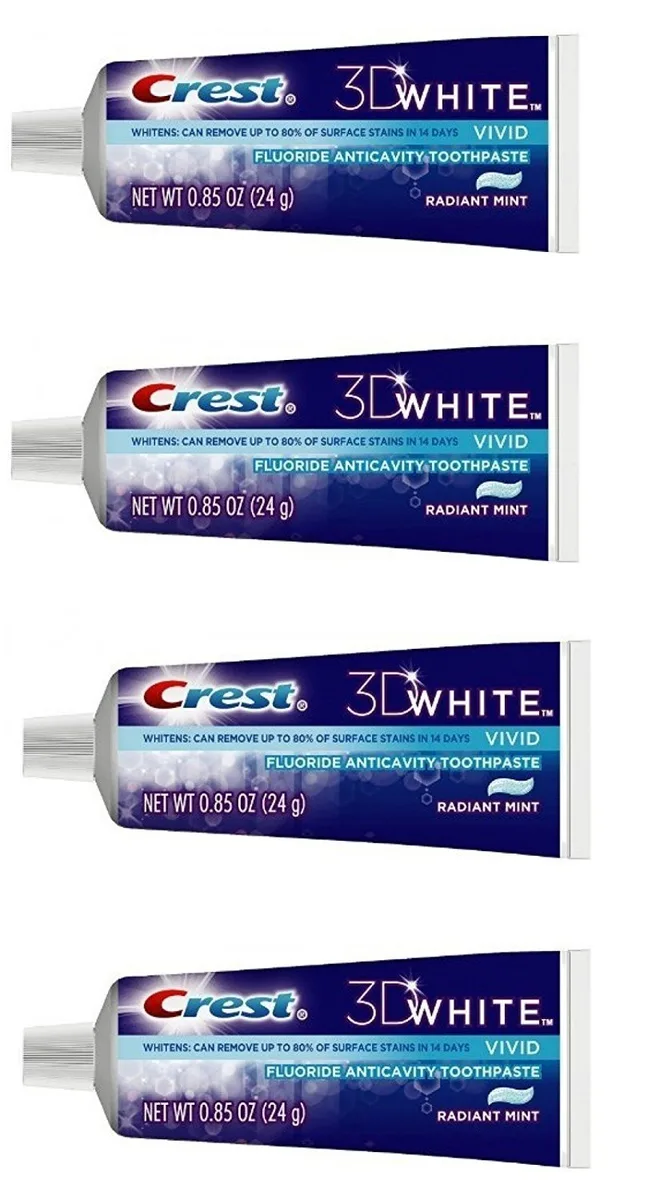 Four small white toothpaste tubes in cardboard packaging