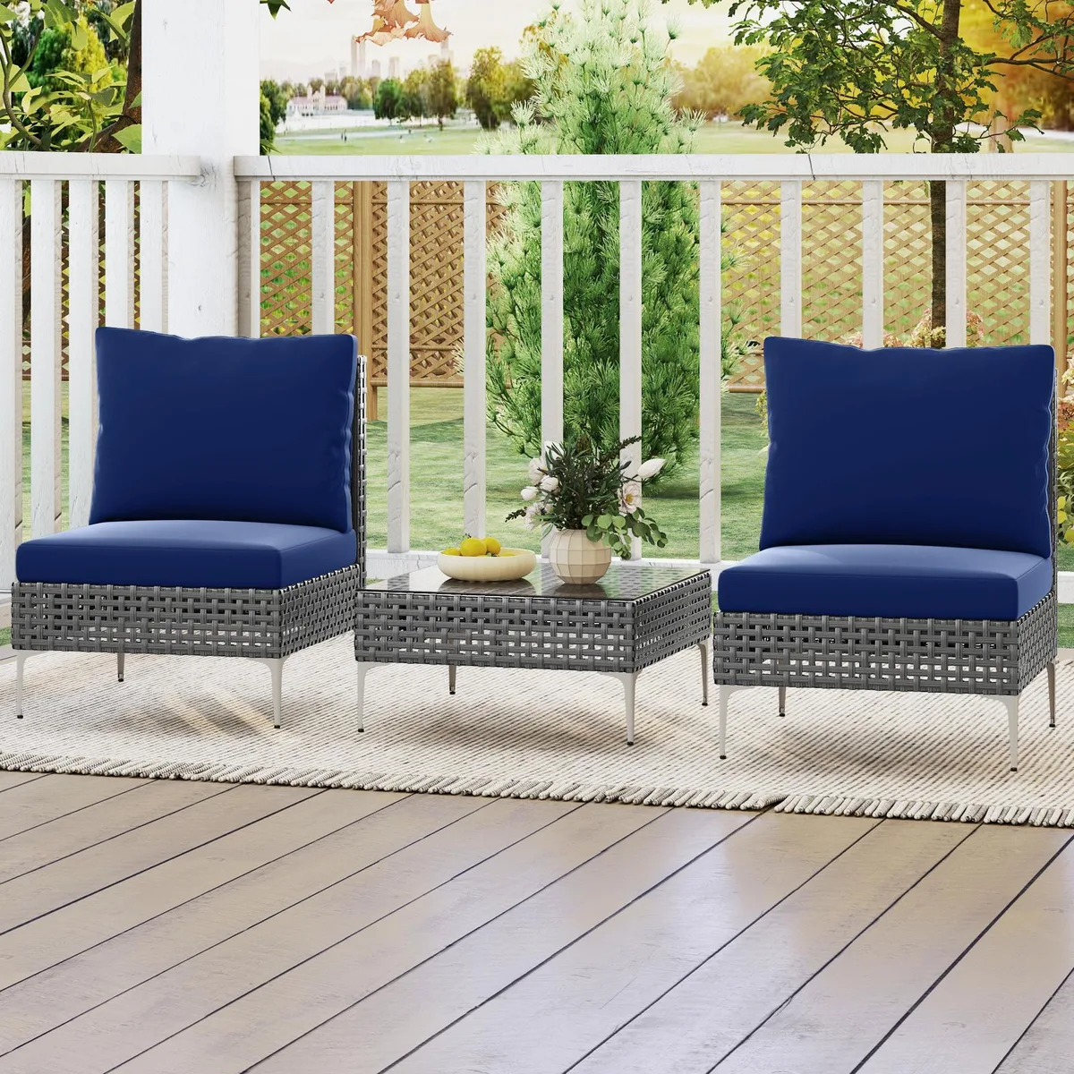 Three-piece navy rattan seating set with glass table and blue cushions