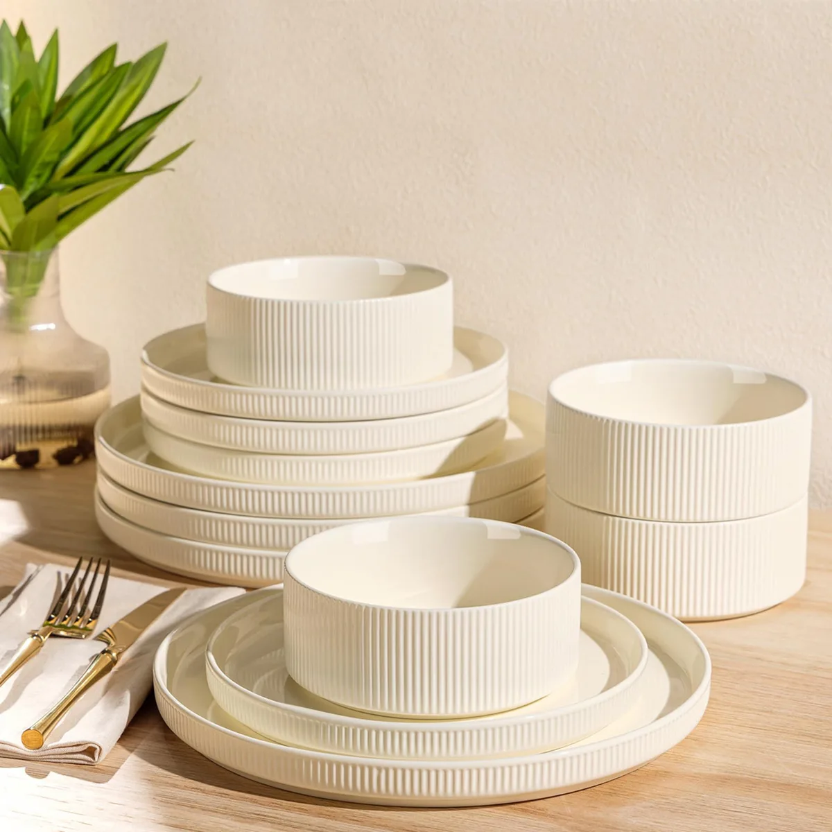 White ceramic 12-piece dinnerware set with beige floral rim design, four dinner plates, salad plates, and cereal bowls