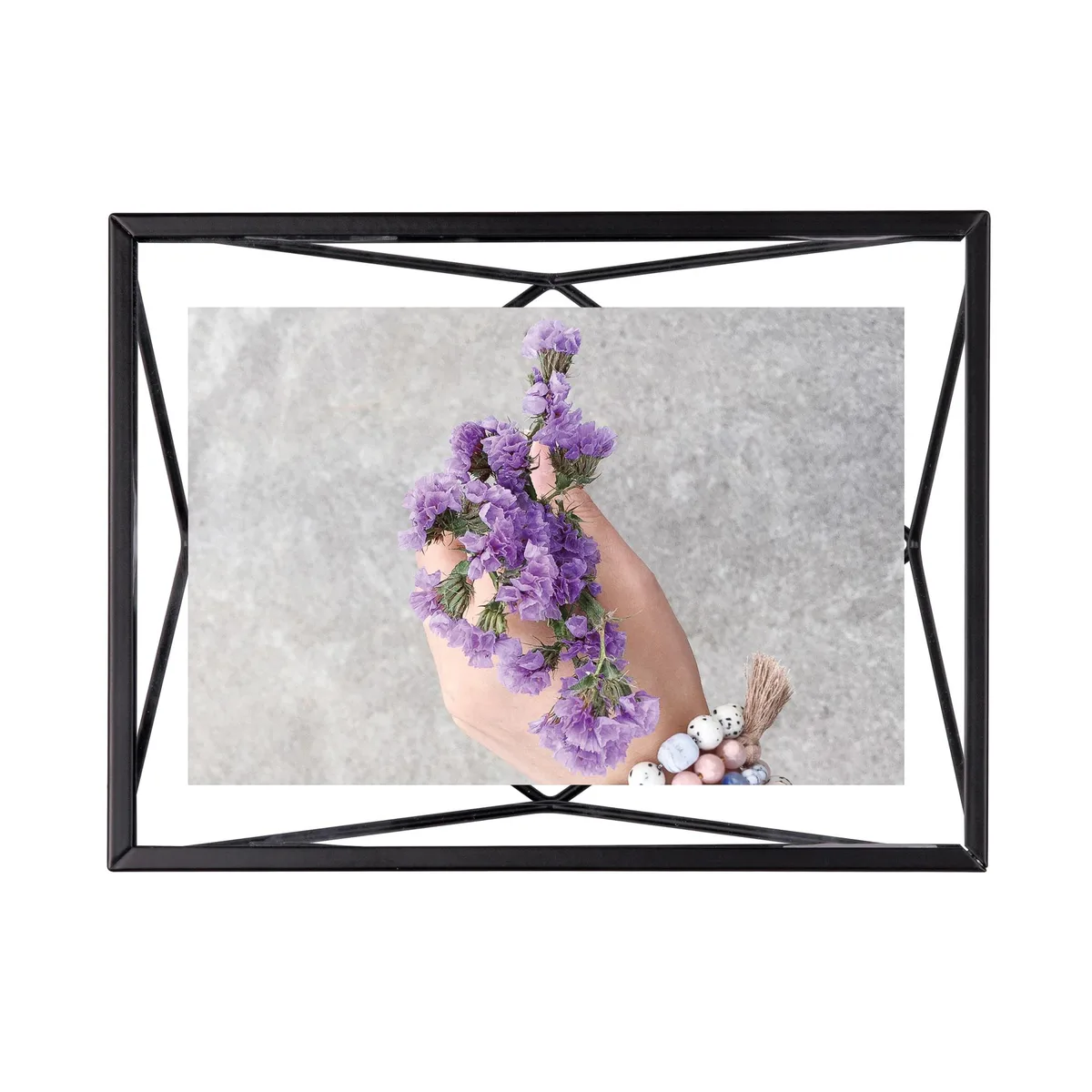 Black geometric wire frame holding a photo between two glass panes