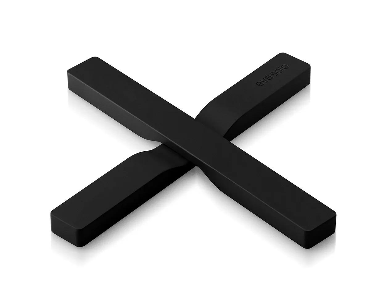 Two black round silicone-coated nylon trivets with built-in magnets