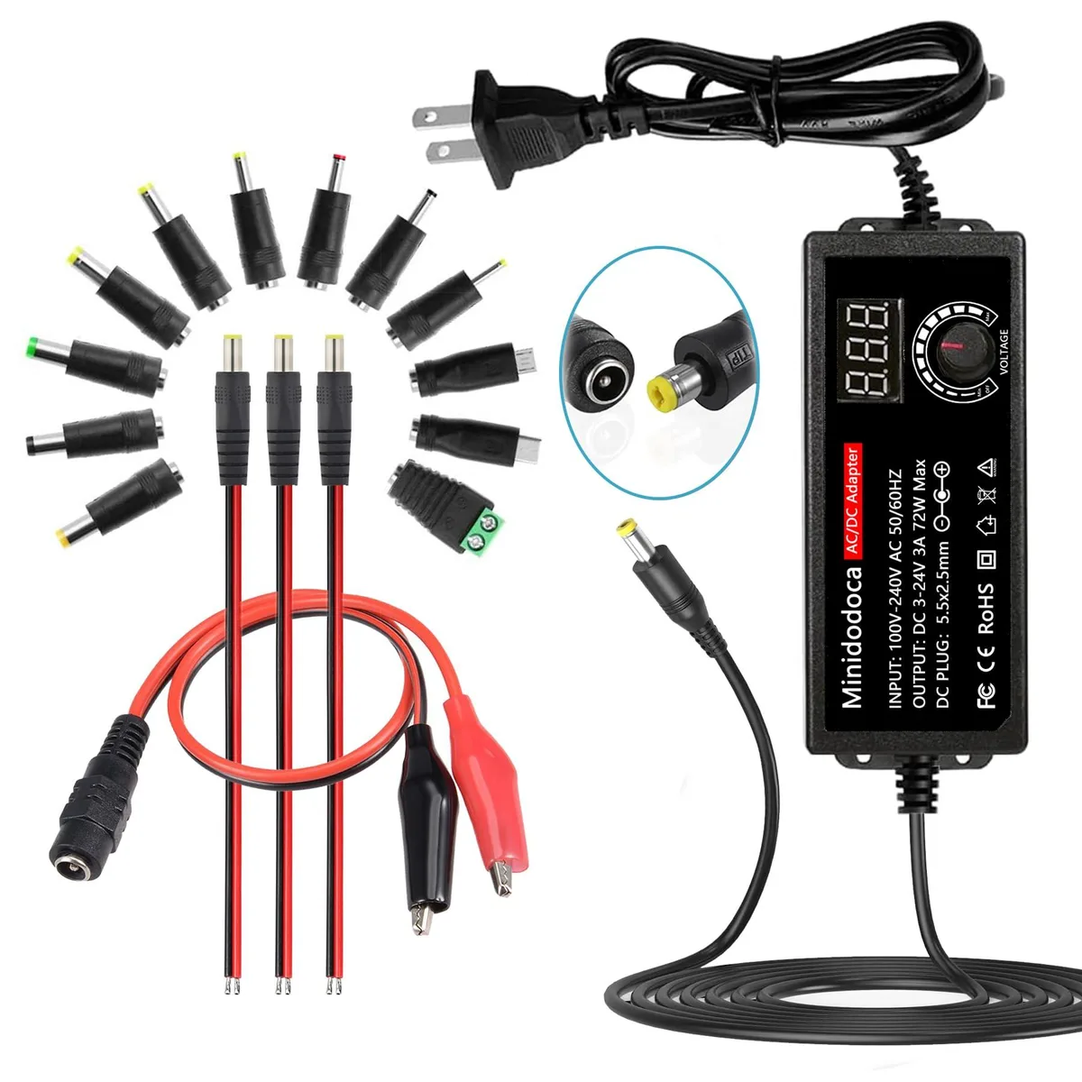Black rectangular power adapter with front LED display, rotary voltage knob and bundled tip assortment