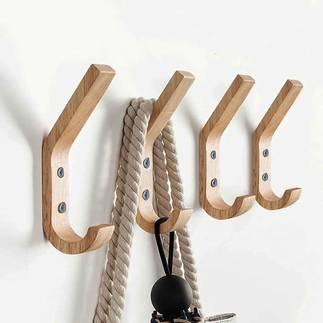 Four natural oak wall hooks with curved double-peg design and visible wood grain