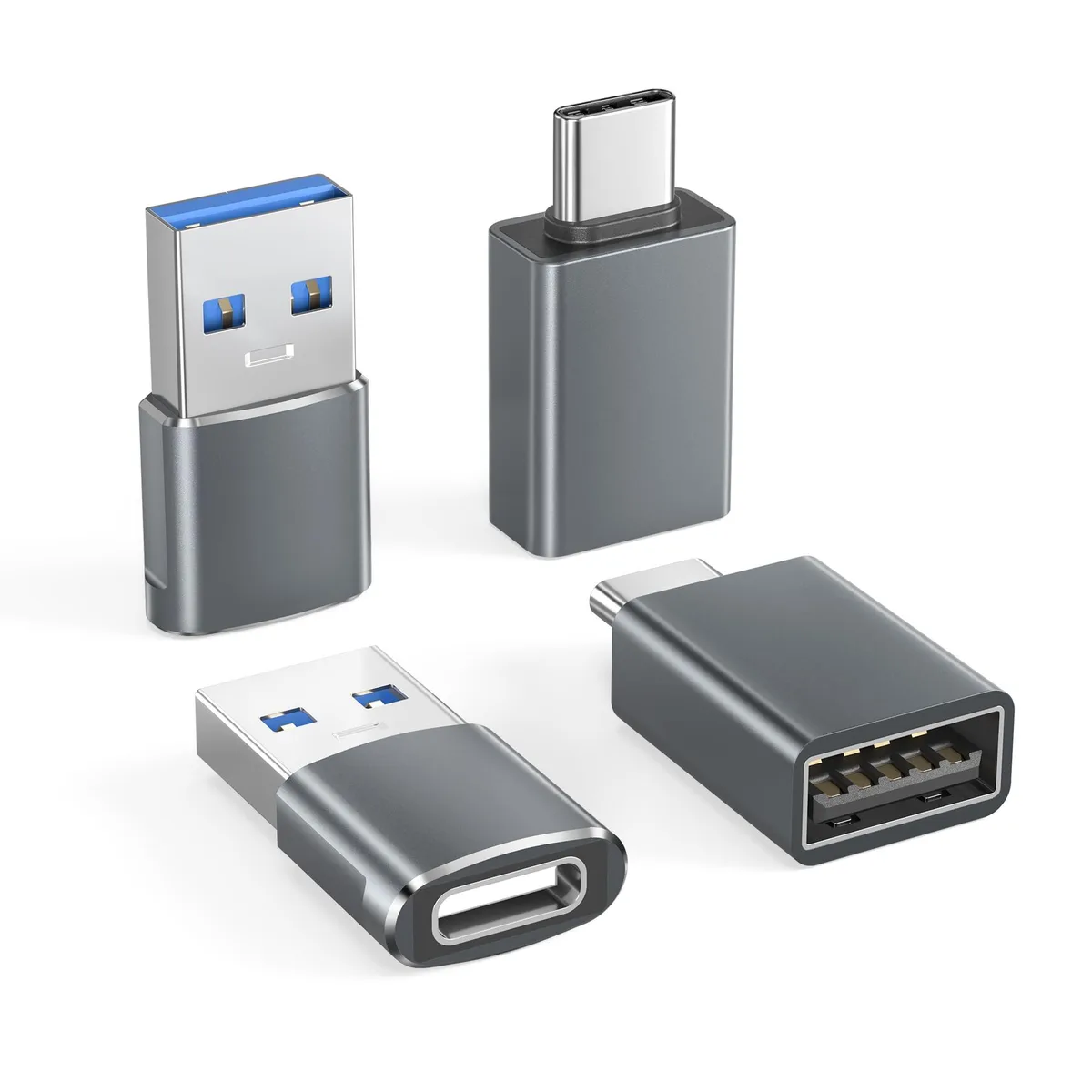 Four small grey USB adapters, two with USB-C plugs and USB-A ports, two with USB-A plugs and USB-C ports, aluminium casings