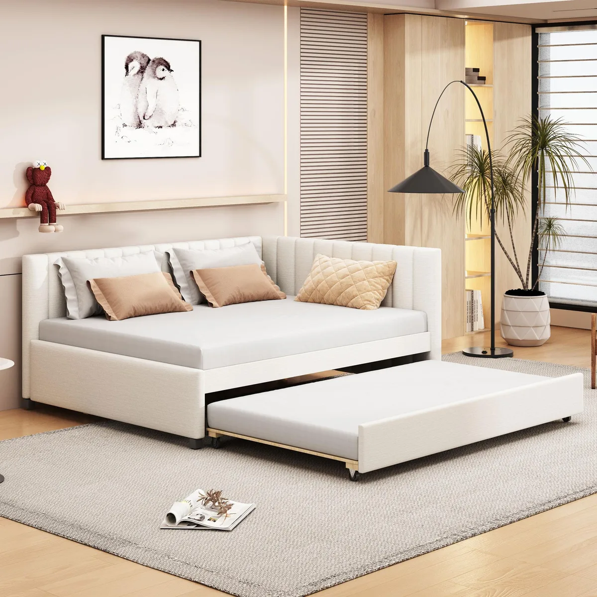 Beige linen upholstered daybed with pull-out trundle, low backrest and wooden slats