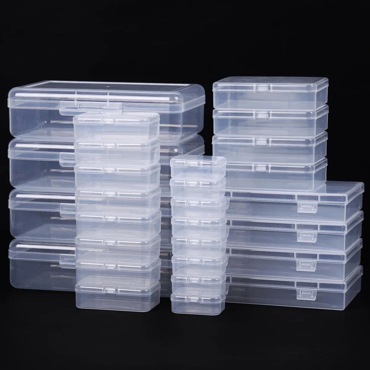 Twenty-eight clear rectangular plastic boxes with lids in assorted sizes