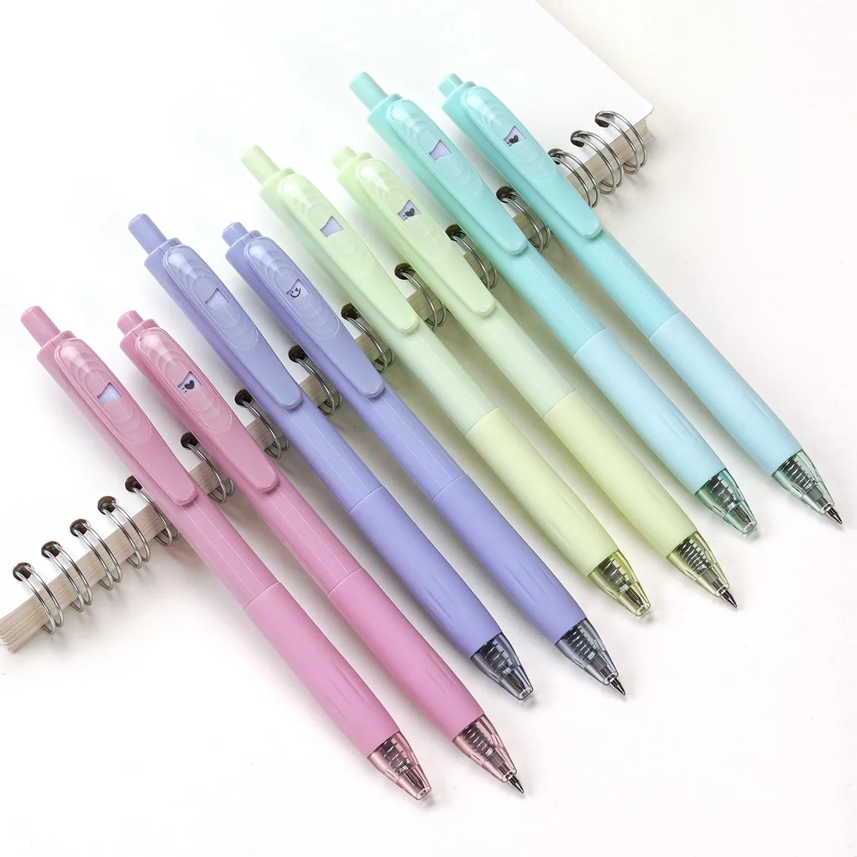 Eight retractable gel pens, 0.7 mm tips, coloured plastic barrels, special clips