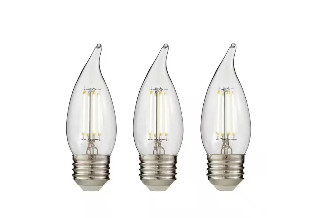 Three clear flame-tip LED bulbs with visible filaments, E26 bases
