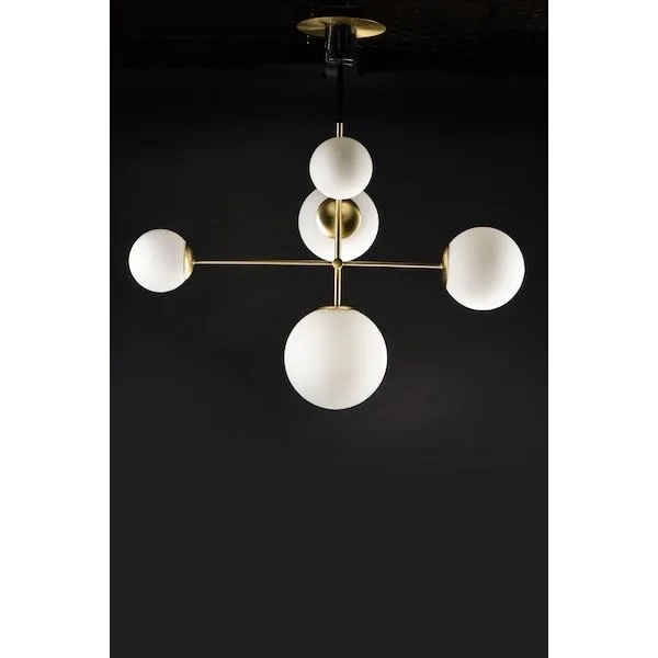 Satin brass pendant with five white glass globes and black metal marble accents