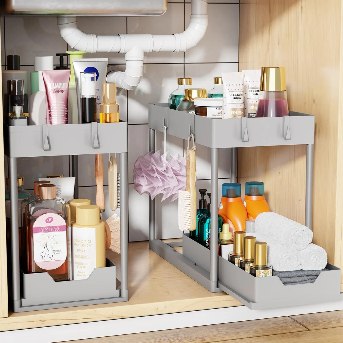 Two grey painted sliding under-sink storage units with pull-out lower tier and hooks