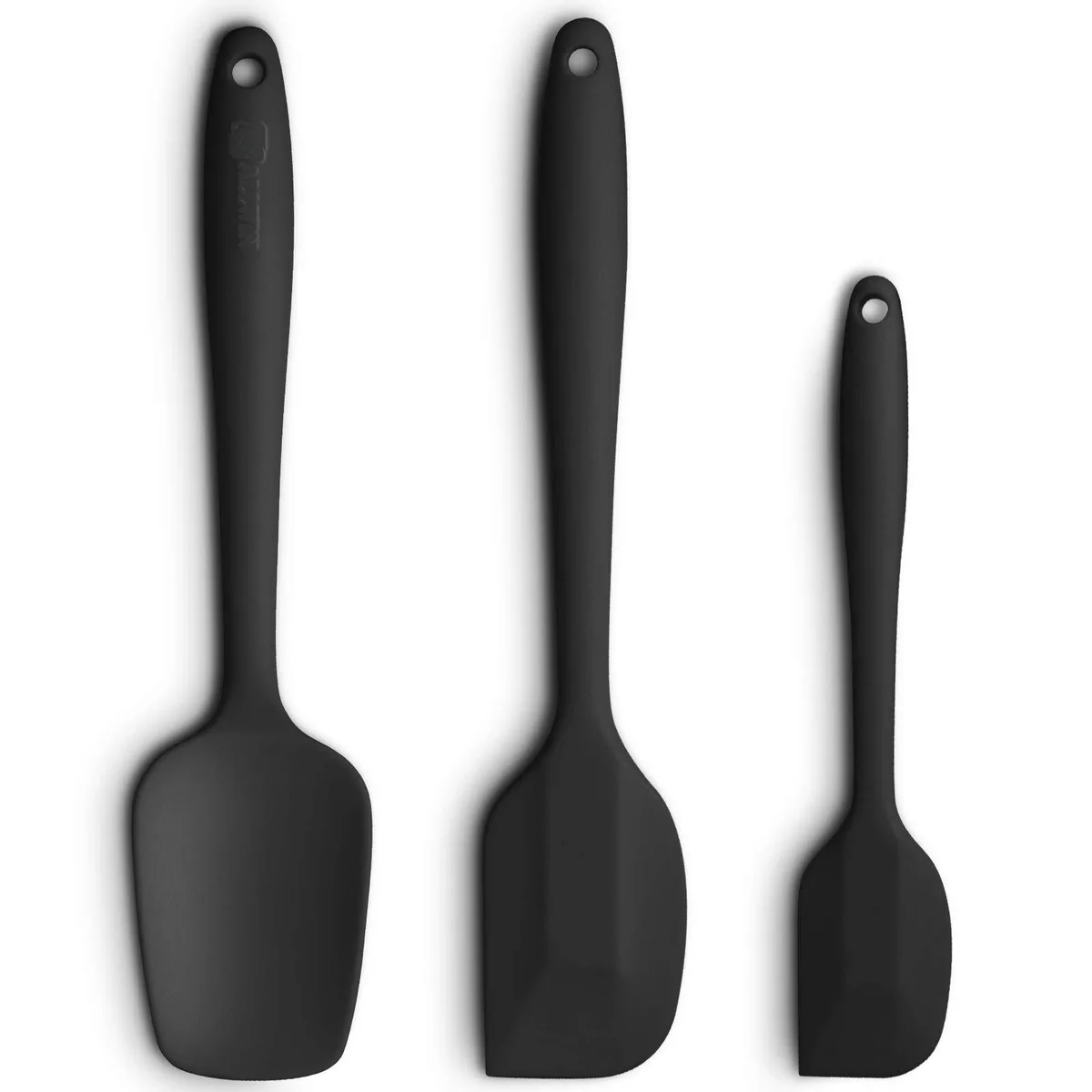 Three black silicone spatulas with ergonomic handles, seamless one-piece design, varying head shapes