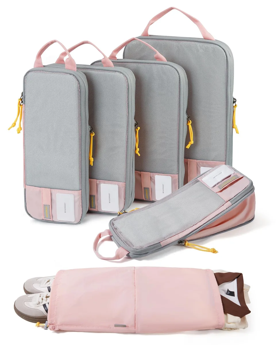 Six pink fabric cubes with compression zippers and handles