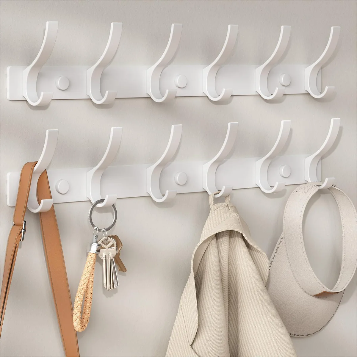 White wall-mounted coat rack with twelve rounded hooks on a 15.7 in bar