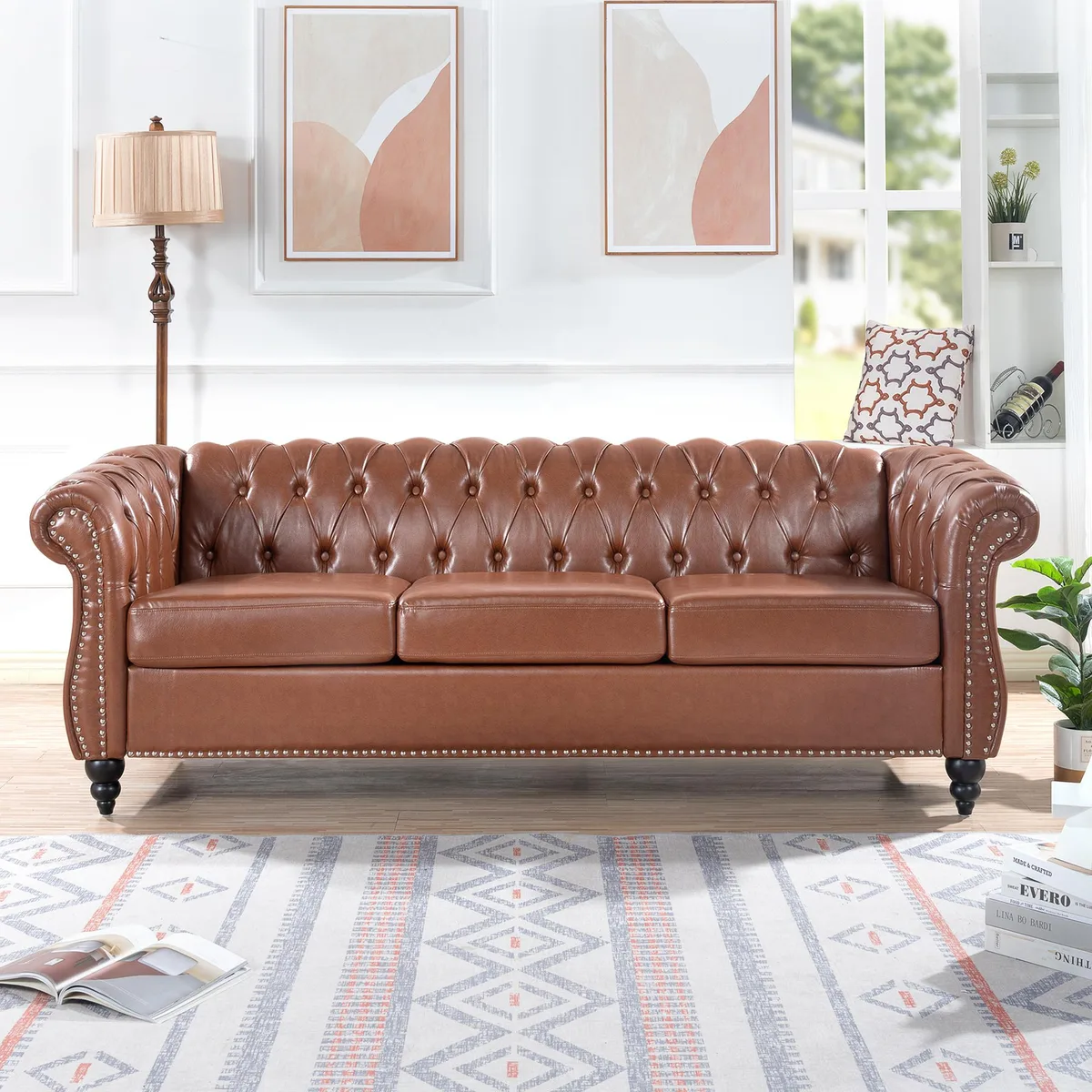 Brown PU Chesterfield three-seater sofa with rolled arms and tufted backrest, birch legs