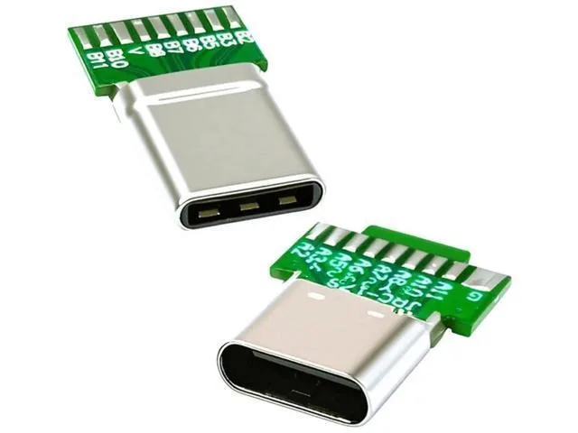 Two small USB-C solder adapters with gold pins on green PCB boards, one male plug and one female socket