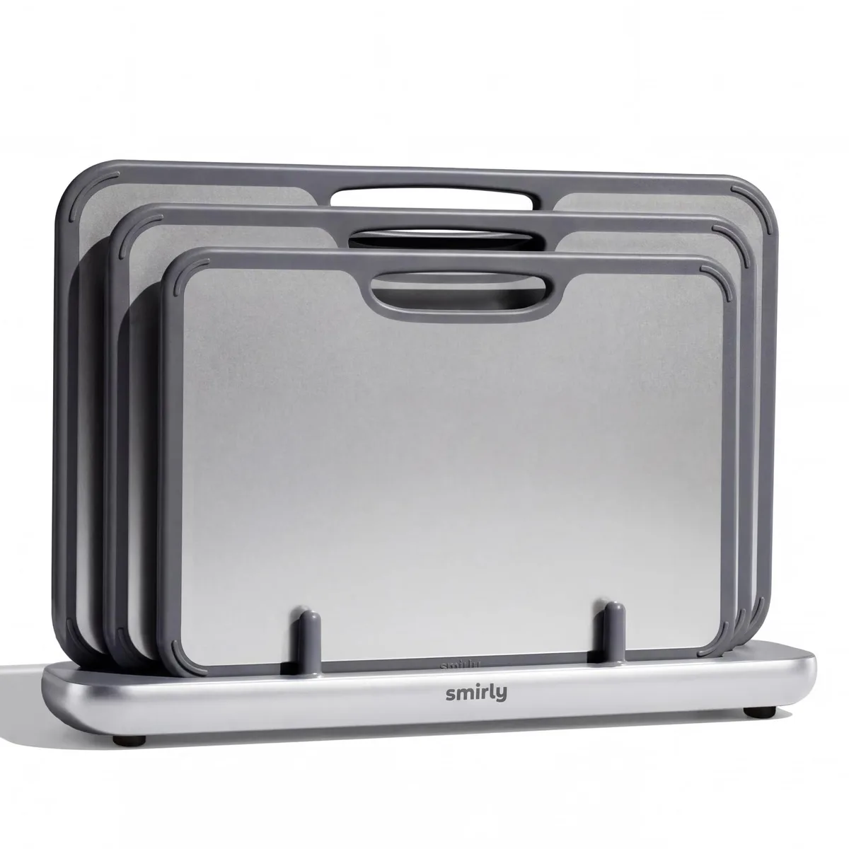 Three silver titanium cutting boards in a holder