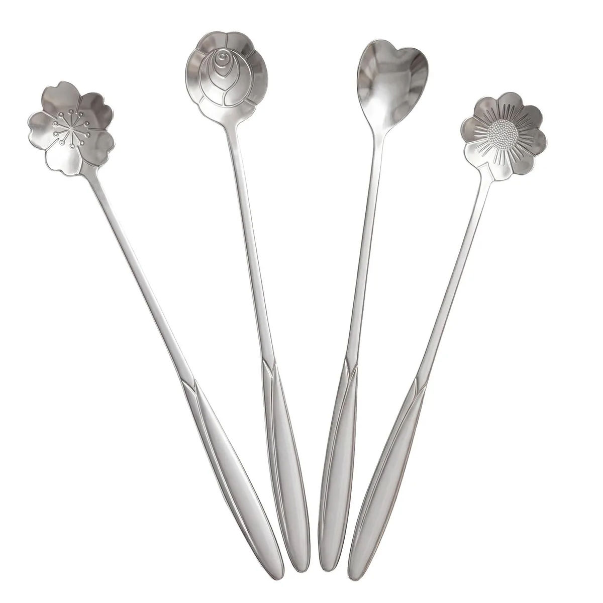 Four silver stainless steel teaspoons with decorative heart, flower and cherry shaped handles lying flat