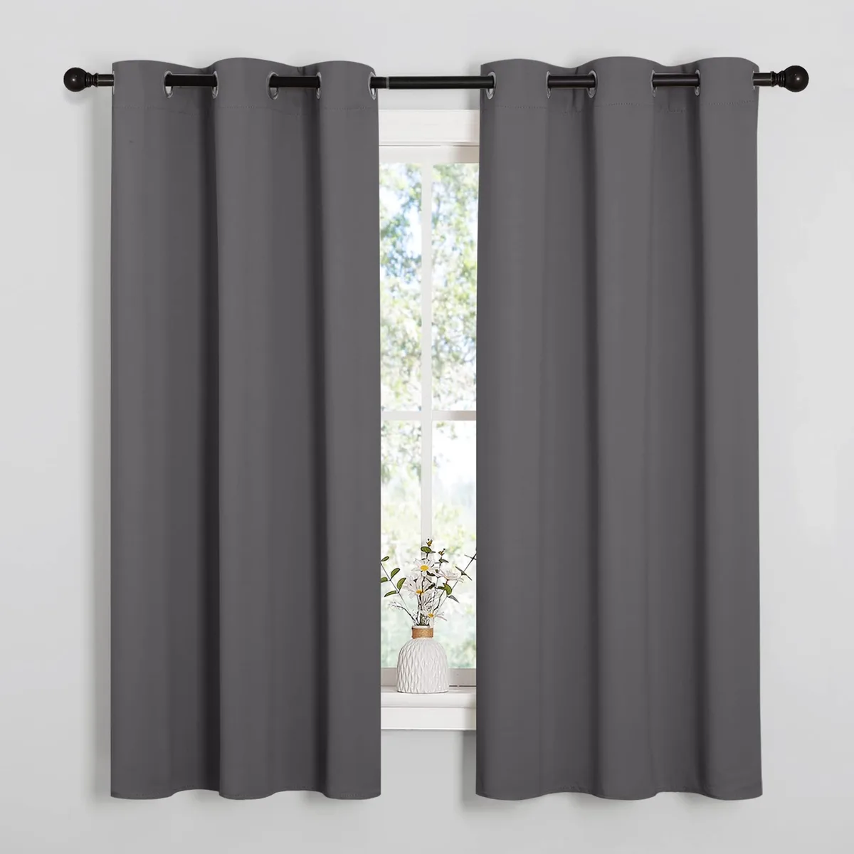 Two grey blackout curtain panels with silver grommets, 42 by 63 inches