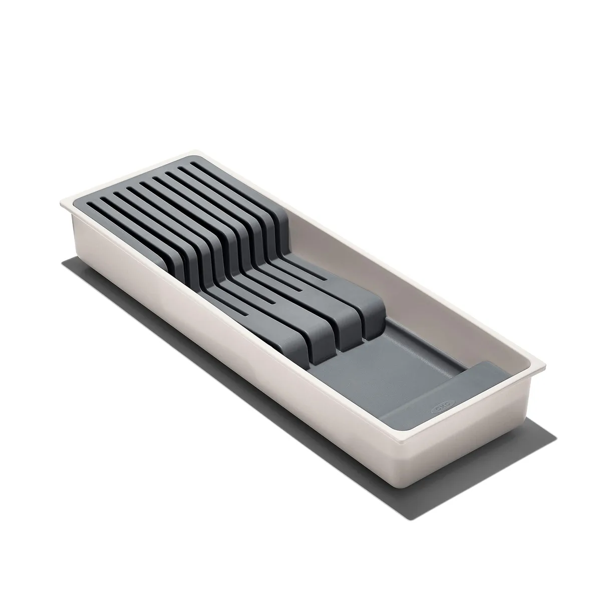 White rectangular plastic drawer organizer with angled knife slots and non-slip feet