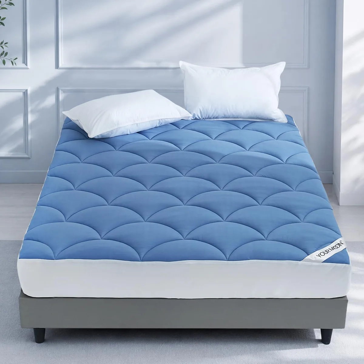 Blue quilted mattress pad with deep fitted pocket and pillow top surface