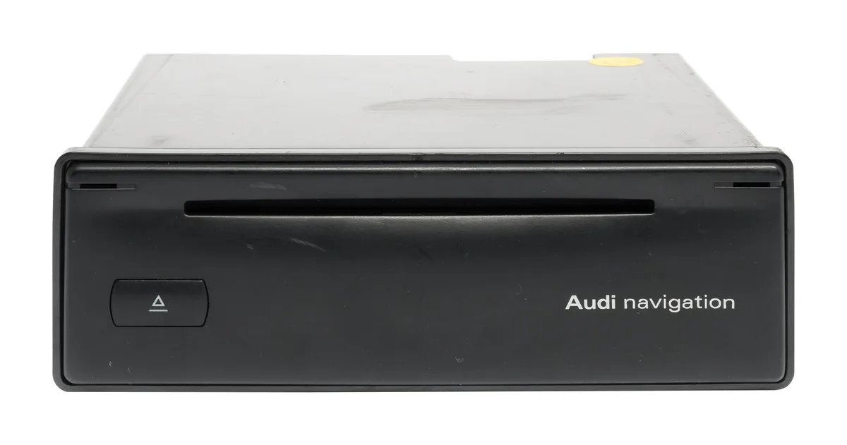 Silver rectangular metal trunk-mounted navigation CD reader unit with front label and connector port