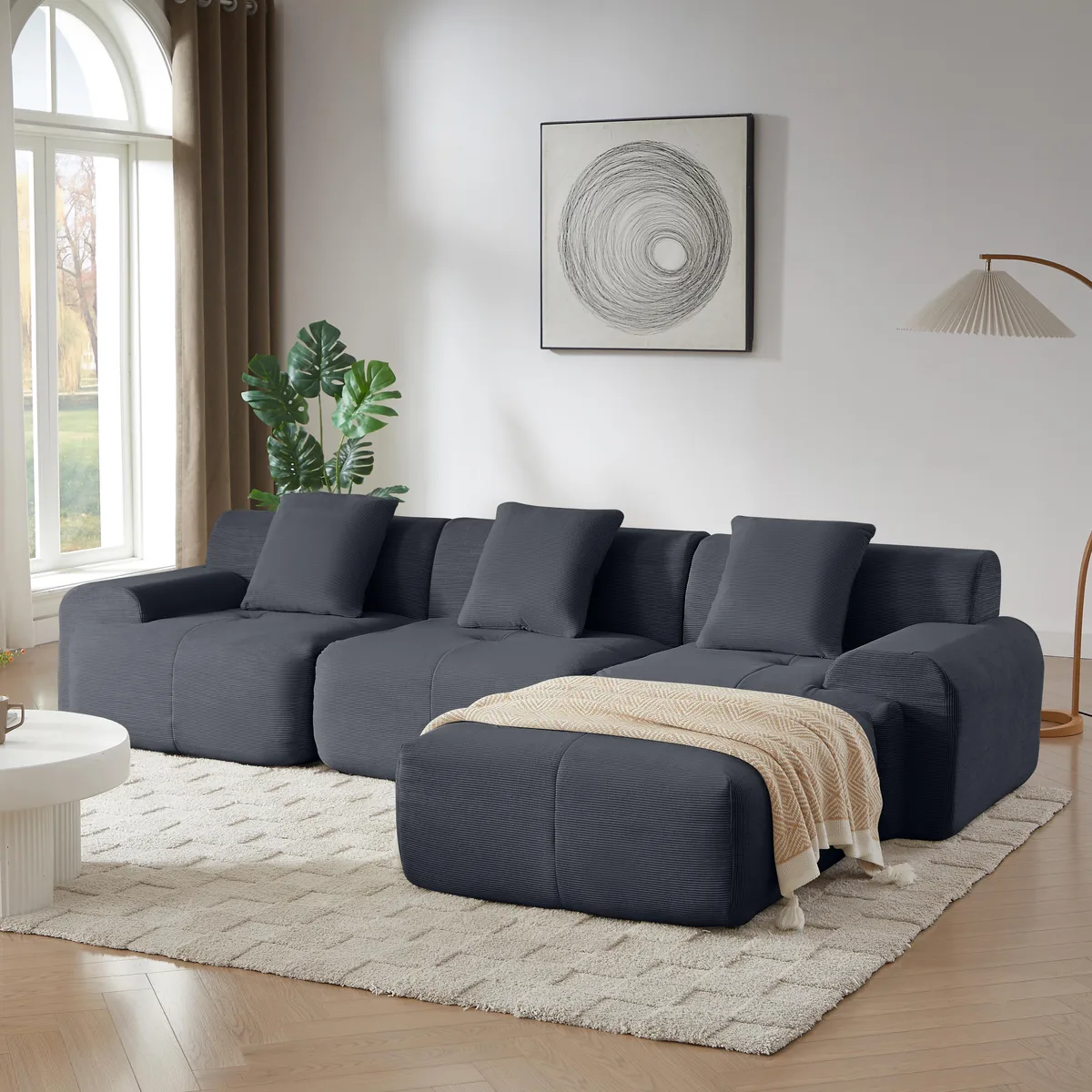 Large L-shaped modular sectional in dark gray corduroy with movable ottoman and throw pillows