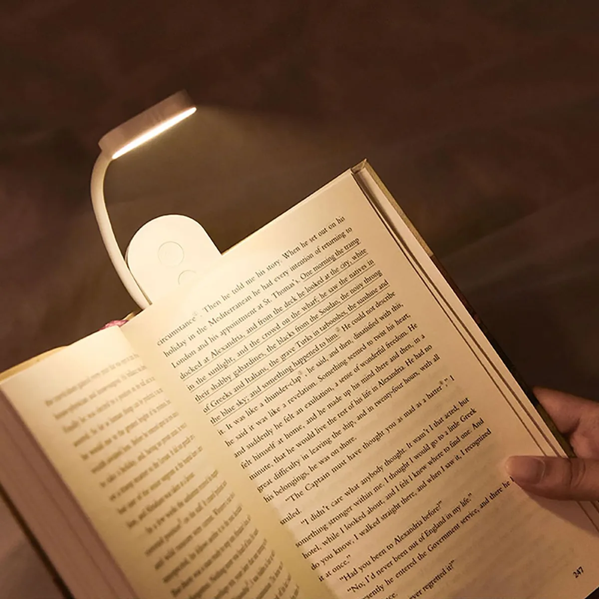 White pocket-sized clip-on book light with foldable head and flexible gooseneck