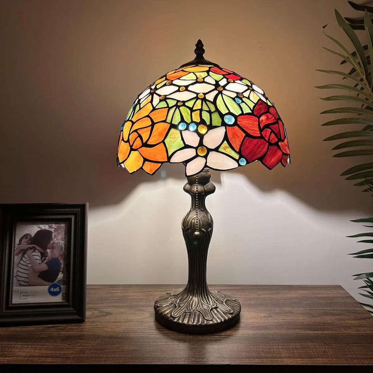 Tiffany-style table lamp with red-orange stained glass rose shade and bronze zinc alloy base