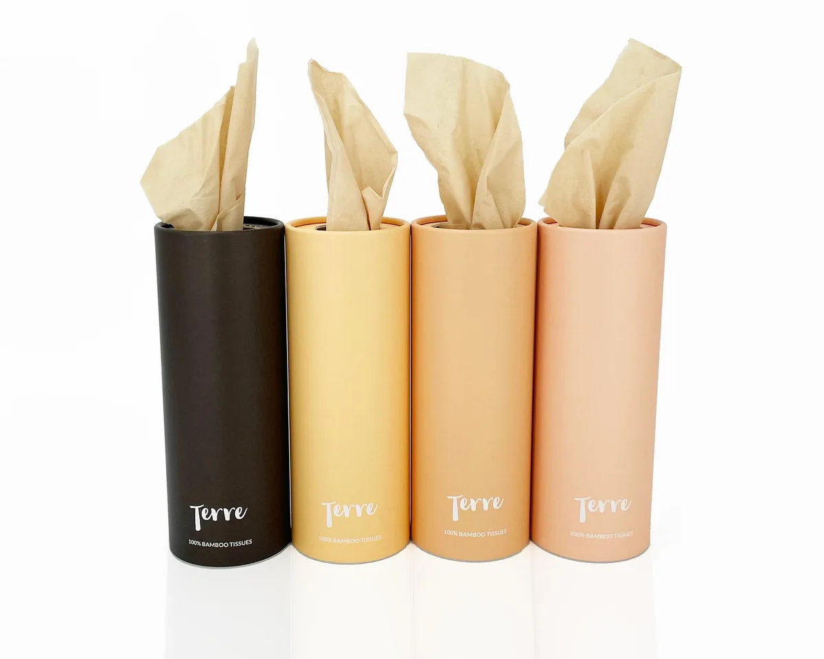 Four cylindrical bamboo tissue refills in a light brown finish