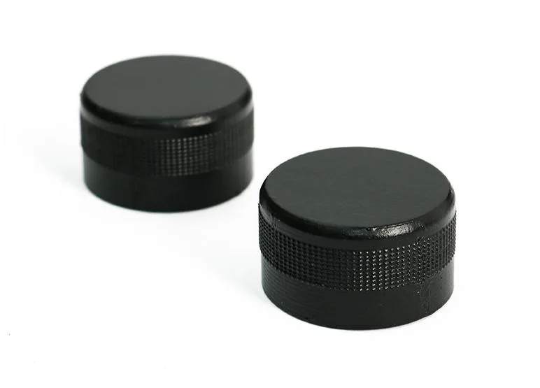 Two small plastic radio knobs, one labelled volume the other tune, light grey finish
