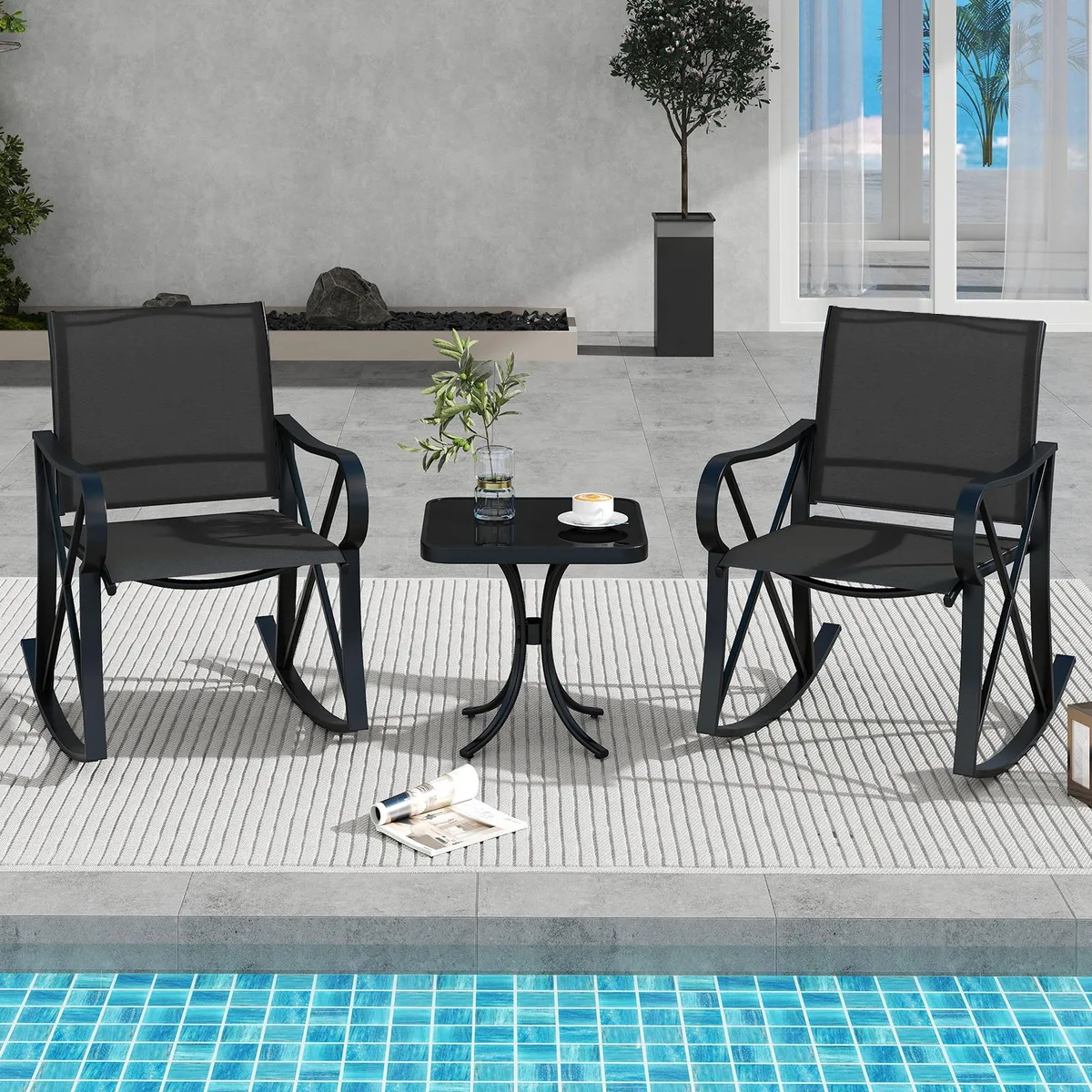 Black three-piece patio rocking set with two chairs and a side table