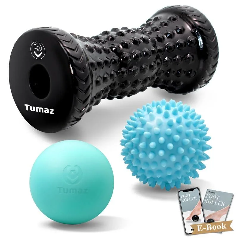 Black polyethylene foot roller and two massage balls on a plain background