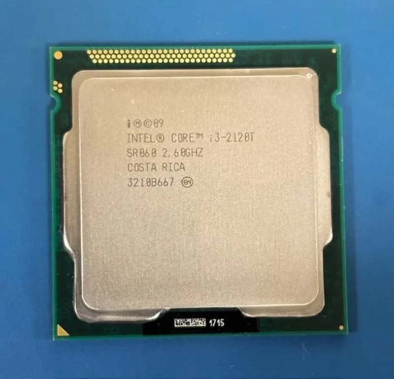 Square green ceramic processor with gold contacts and silver heat spreader marked i3-2120T