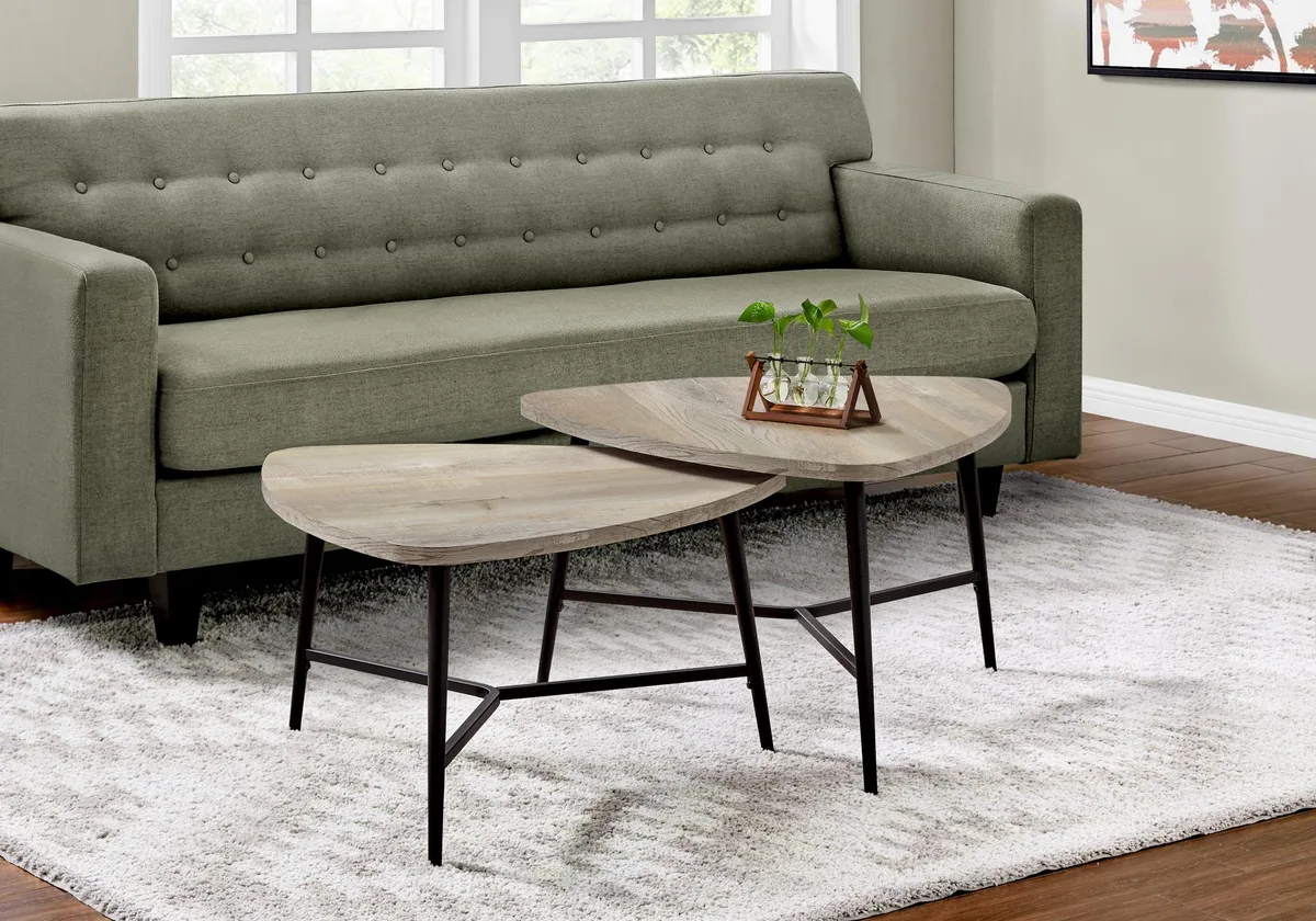 Two nesting tables with taupe triangular tops and black metal tripod legs