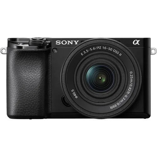 Compact black mirrorless camera body with silver 16-50mm power zoom lens attached