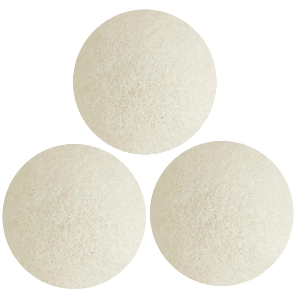 Three oversized white wool dryer balls in hand