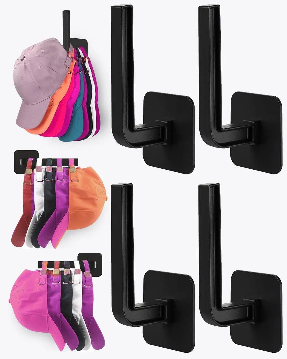 Four black L-shaped acrylic hat hooks on a wall