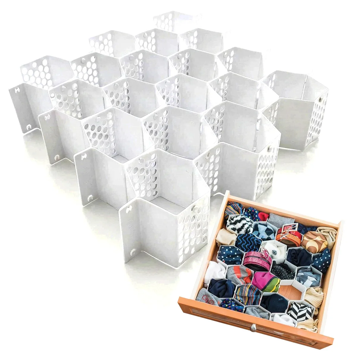 Two white honeycomb drawer organizers with multiple compartments