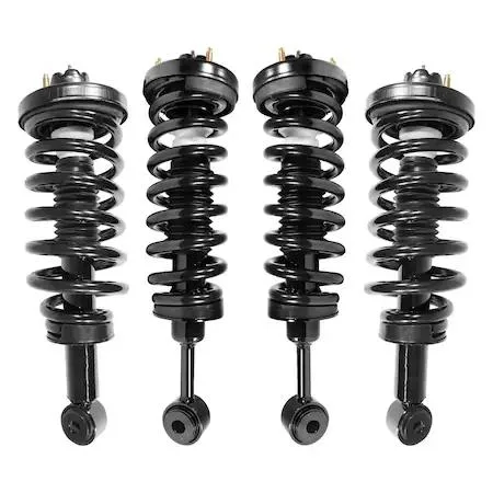 Four silver strut assemblies with black coil springs on a grey background