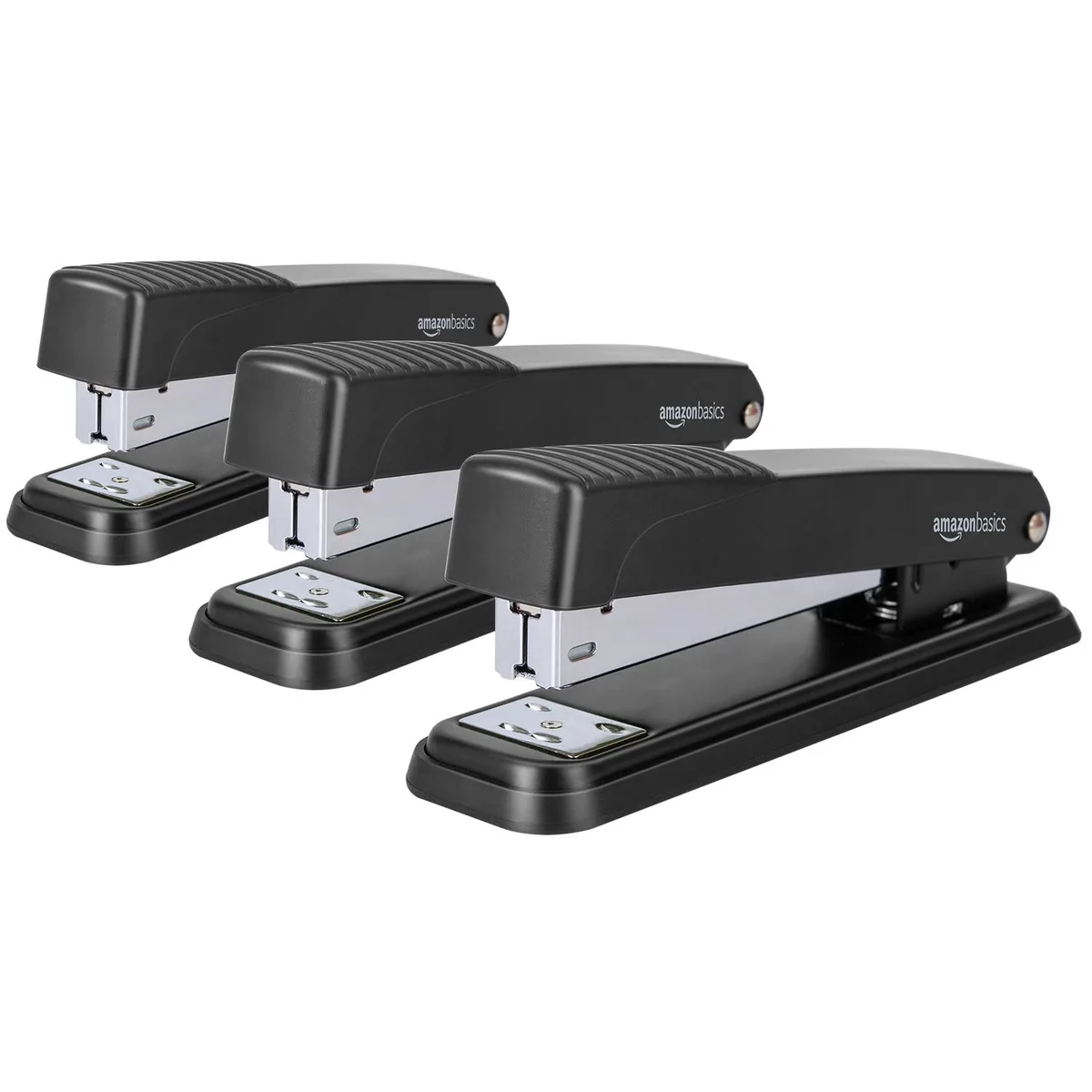 Three black metal desktop staplers with rubber bases