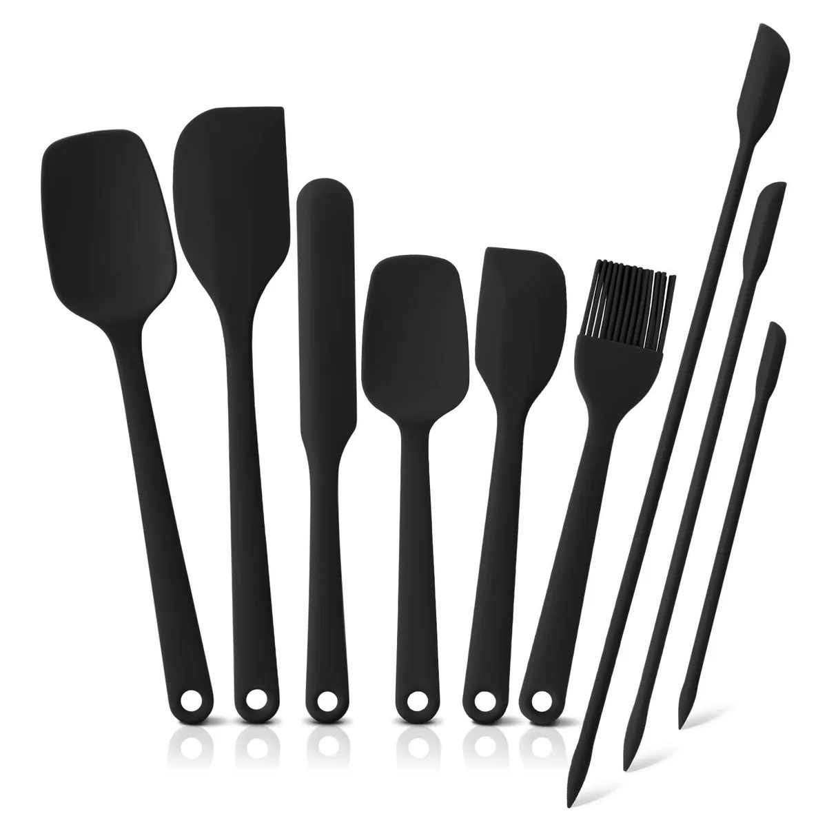 Nine black silicone spatulas with seamless one-piece design, various shapes and sizes, hanging holes visible