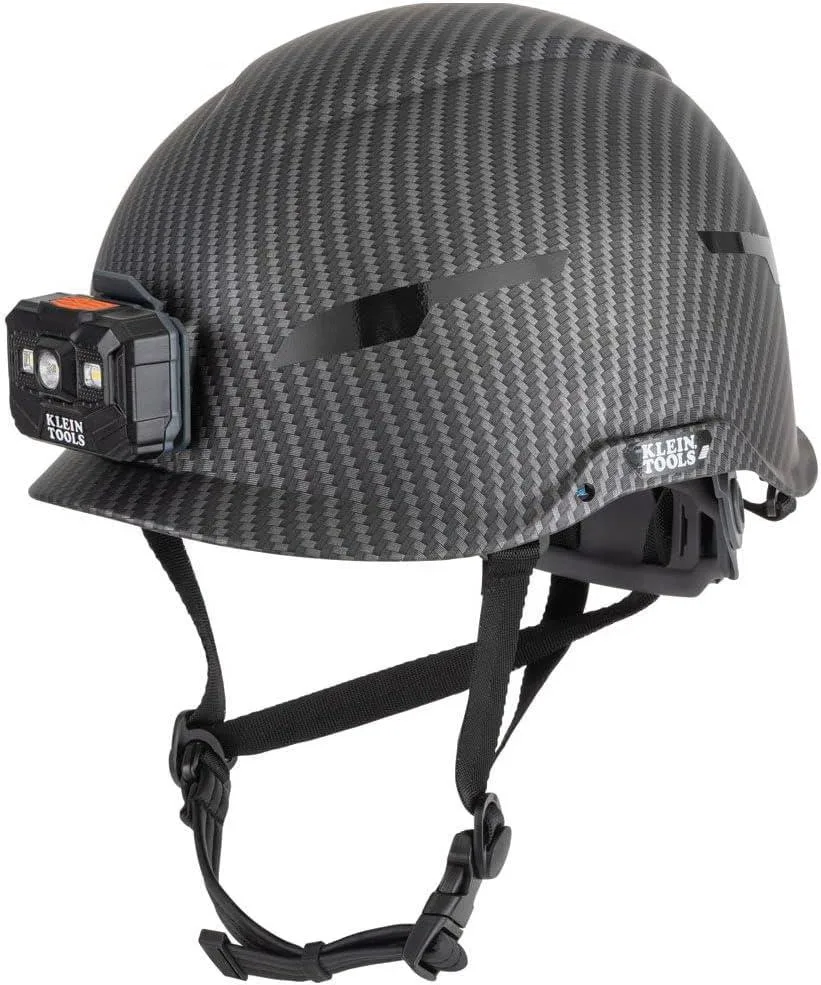 White safety helmet with carbon-fibre pattern, non-vented shell, integrated rechargeable headlamp and chin strap