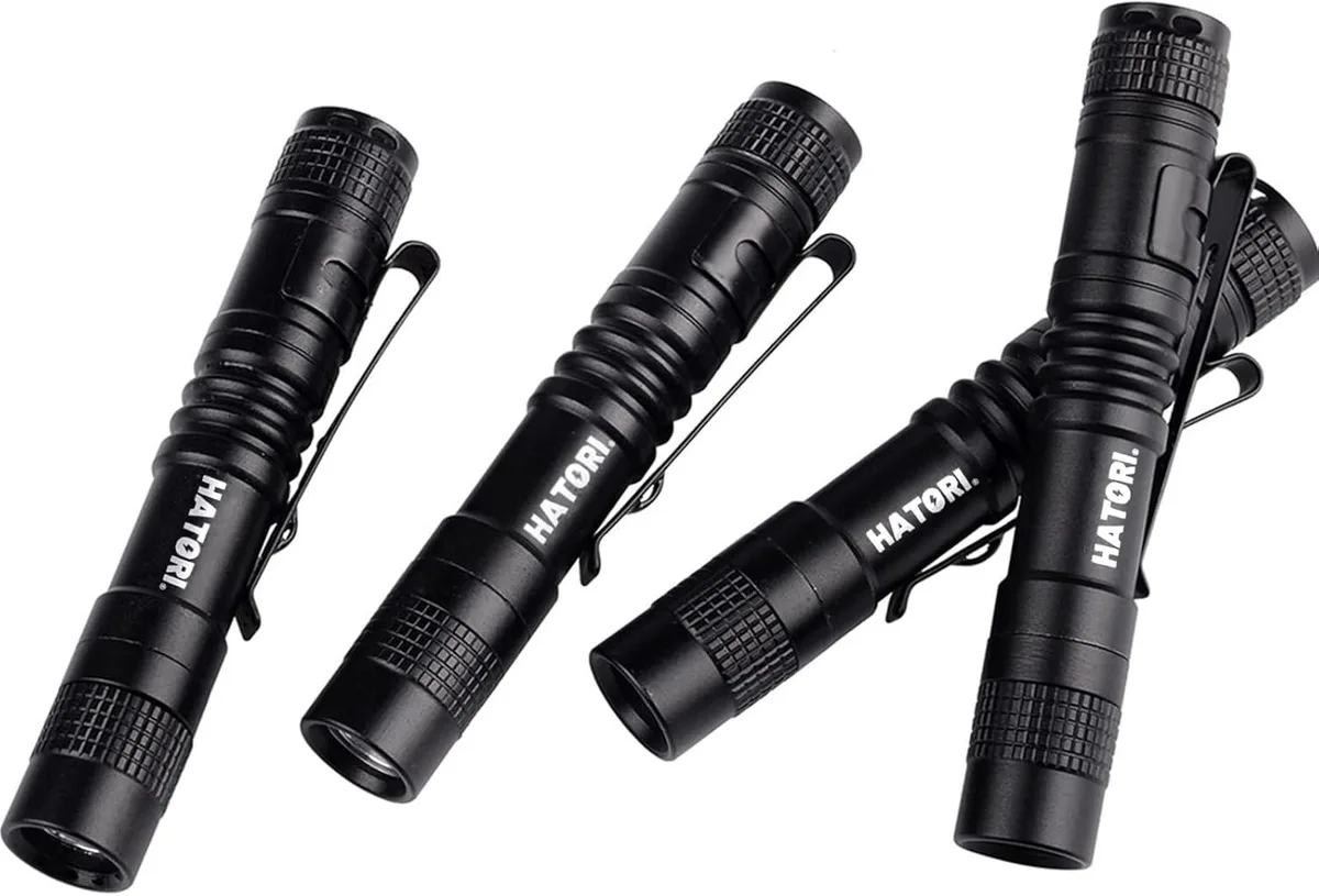 Four silver aluminium pen lights with pocket clips side by side