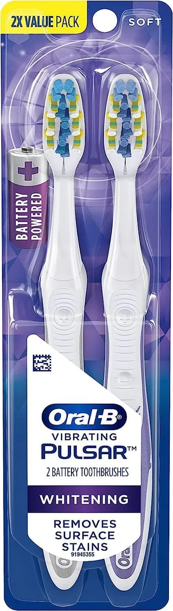 Two soft-bristle battery toothbrushes in multicolor plastic handles with included batteries
