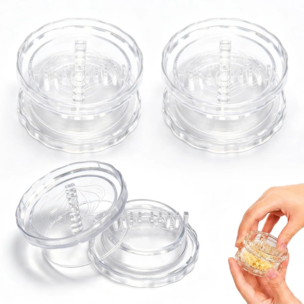 Three clear plastic garlic twisters with twist lids and interlocking teeth