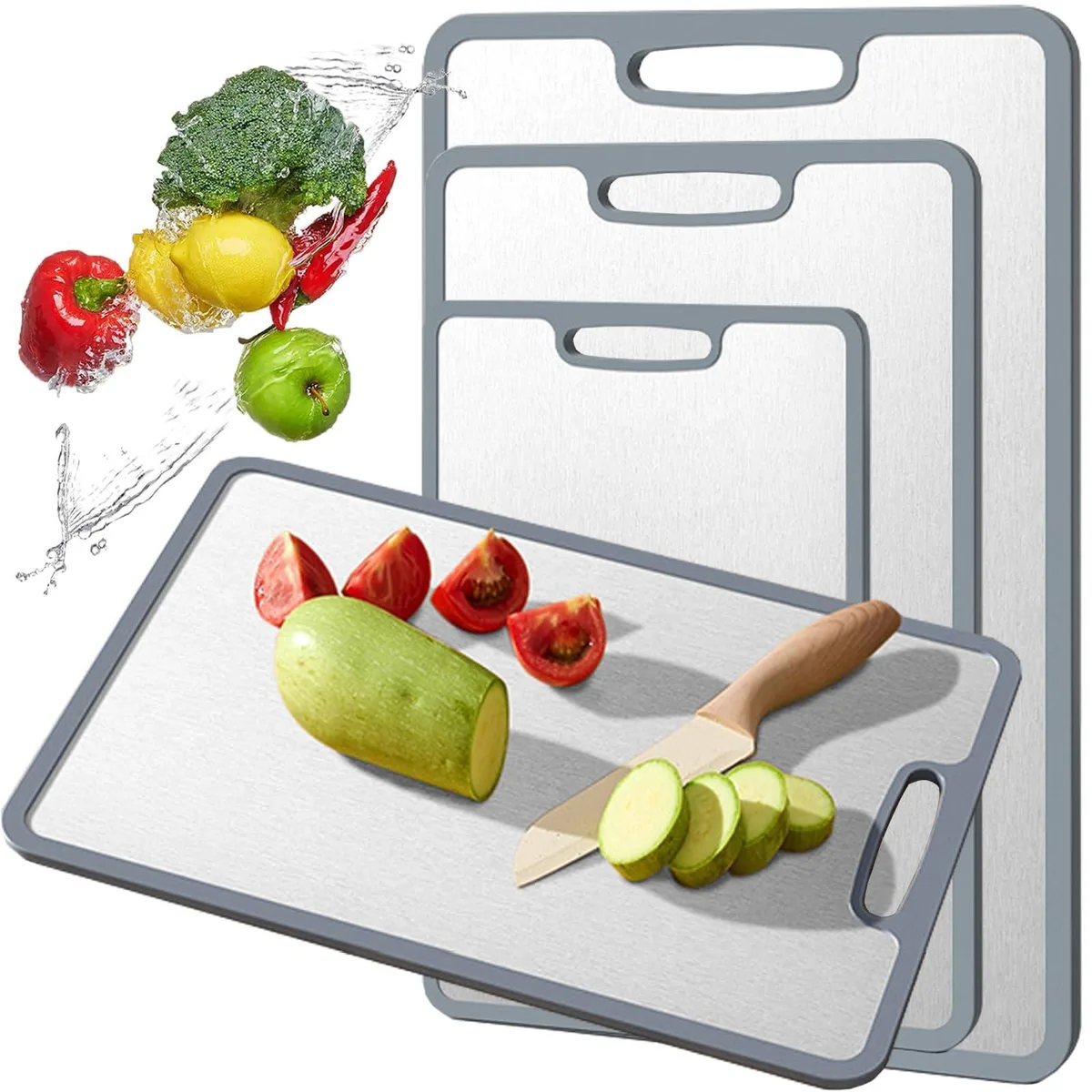 Three rectangular titanium boards in small, medium and large sizes with silicone-wrapped edges and a handle