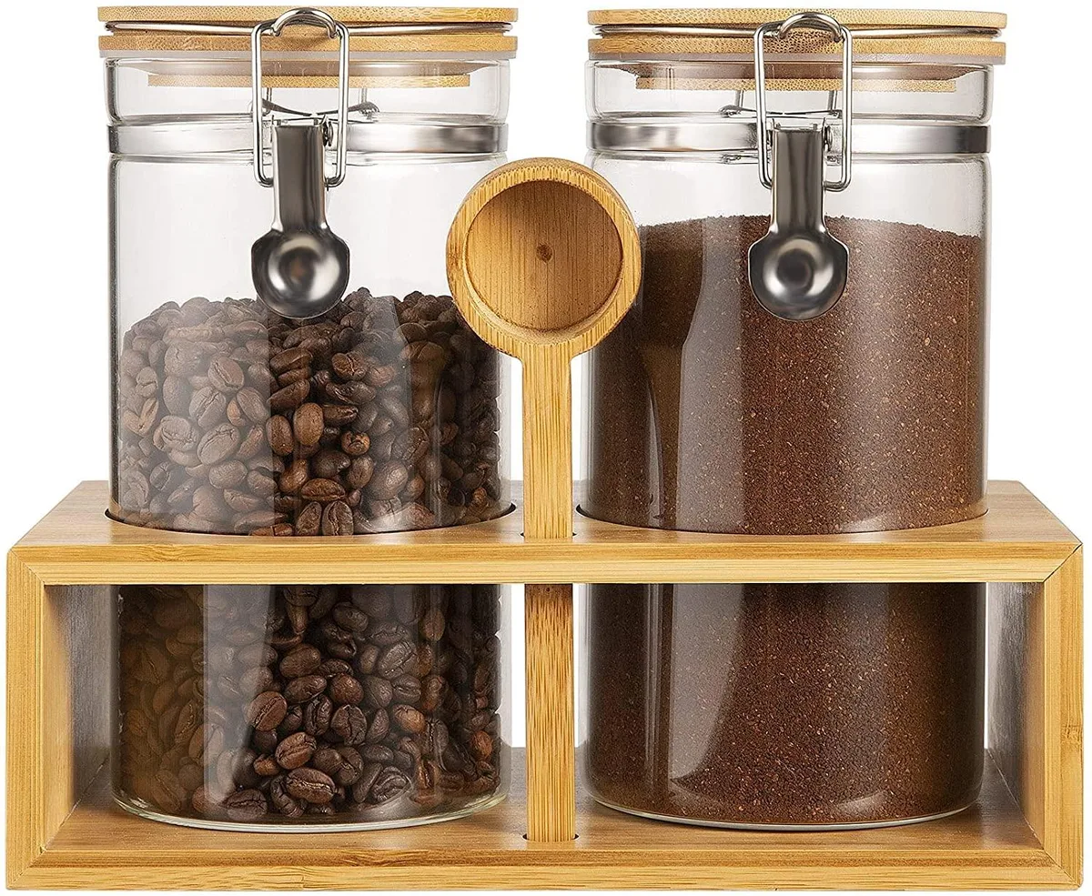 Two clear glass jars with bamboo lids on a bamboo shelf